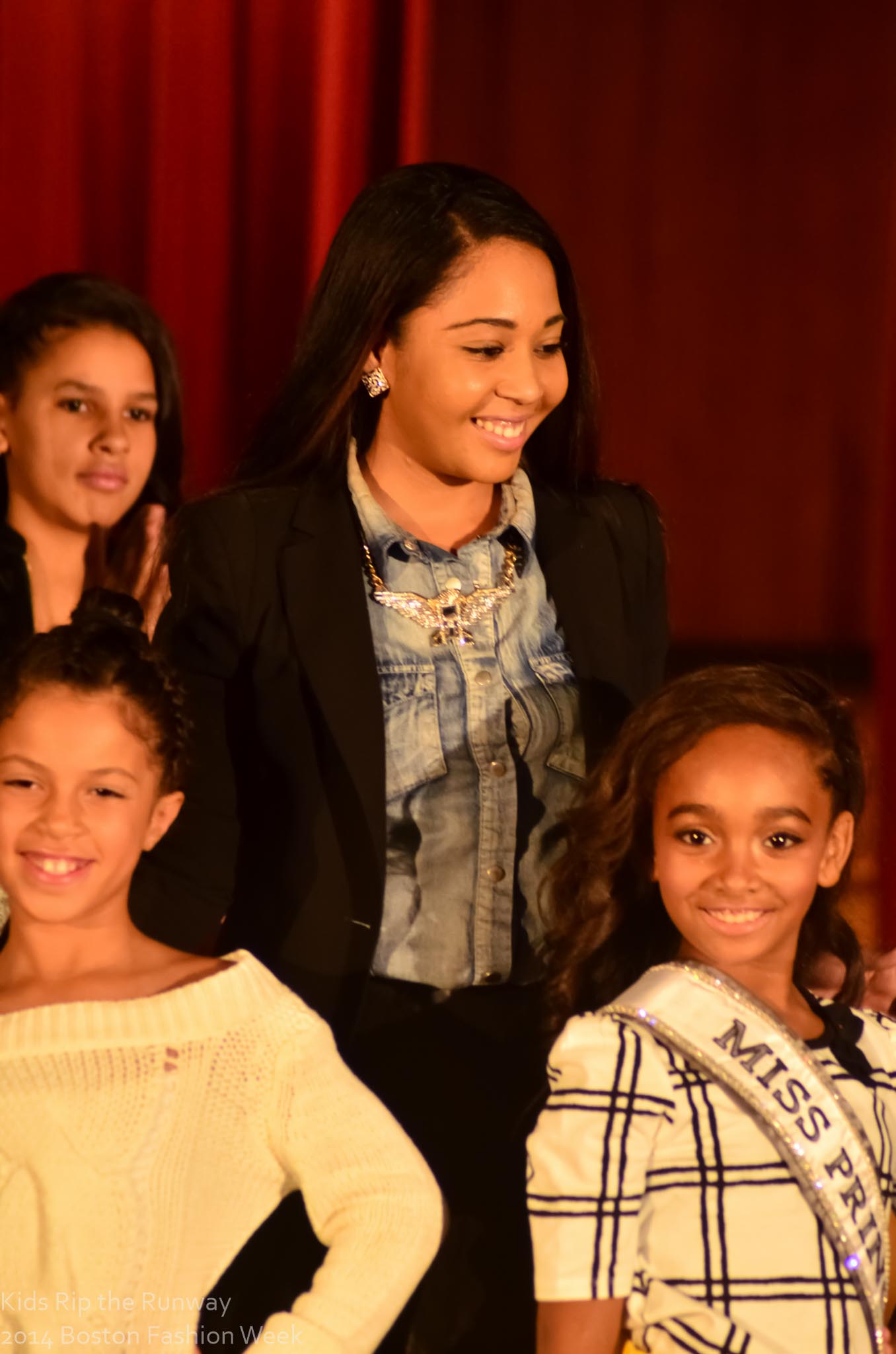 Young Kids Rip the Runway participants and organizers smiling together after the show.
